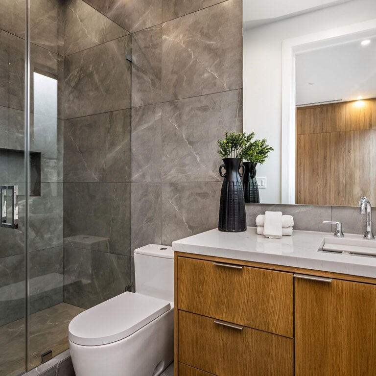 Modern bathroom with wooden vanity and glass shower