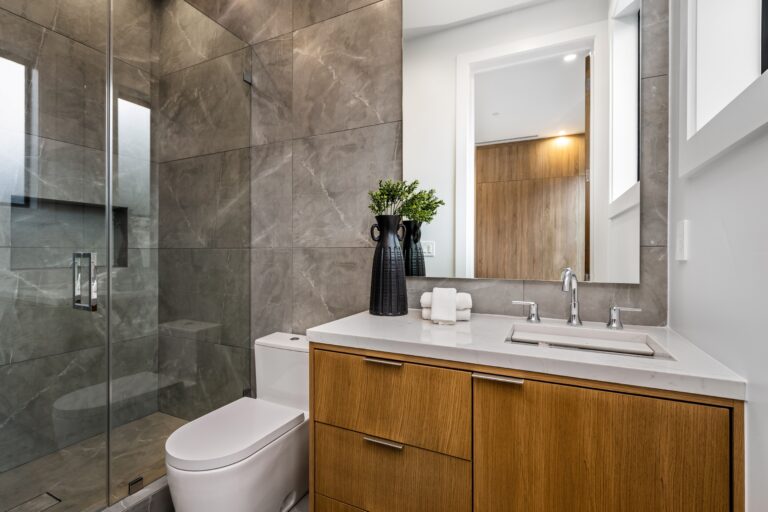 Modern bathroom with wooden vanity and glass shower