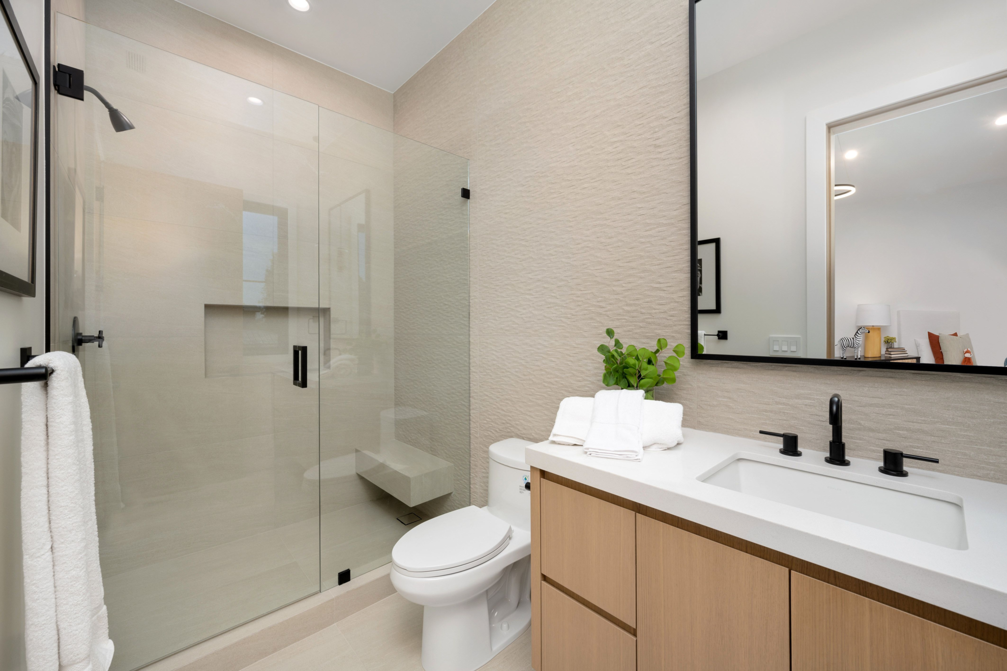 Modern bathroom with glass shower and wooden vanity
